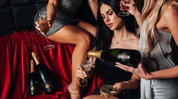 Stylish women enjoying cold glasses of Hotel Collection cava in a luxurious Sora by HC restaurant
